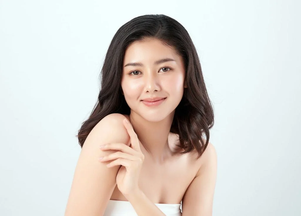 girl with flawless skin smiling at the camera
