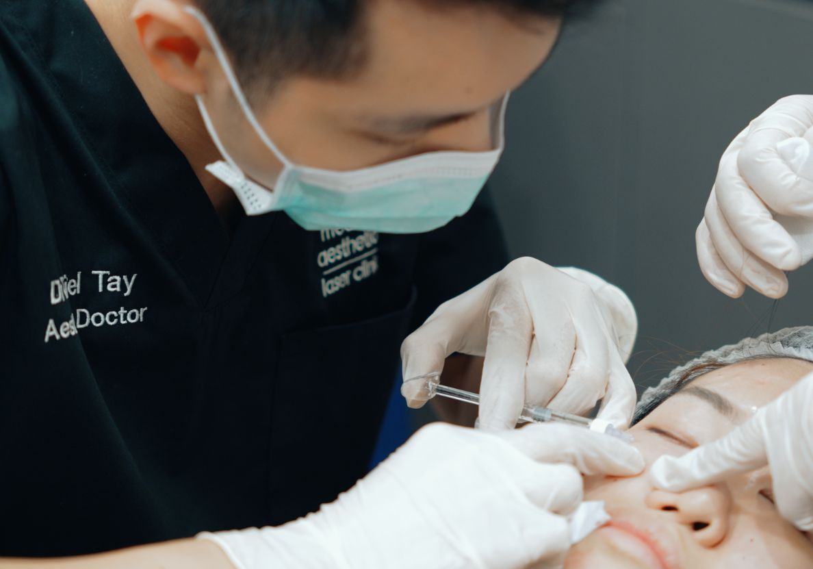 Doctor doing injectables around eyes